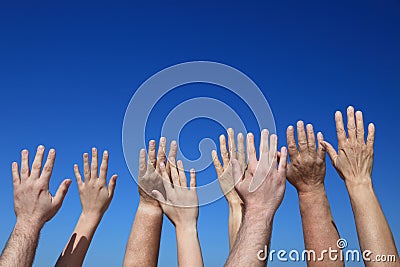 Many hands reaching to the sky