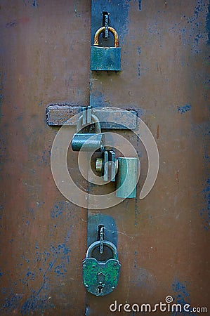 Many locks and bolts on the gate.