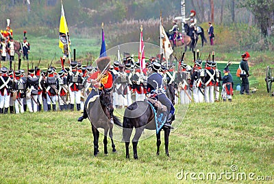 Many soldiers-reenactors fight on the battle field.