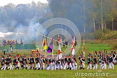 Marching soldiers-reenactors holding flags.