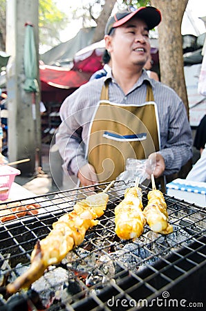 Bangkok, Thailand : Market man selling grilled squ