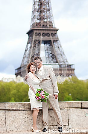 Married couple in Paris, posing near Eiffel Tower