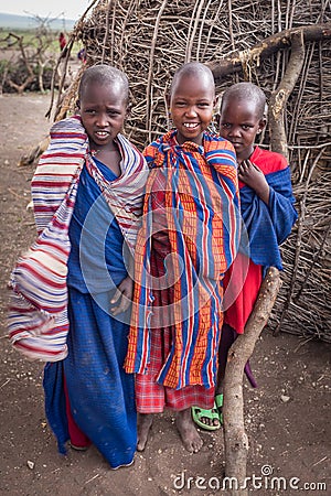 The Masai kids smile with happiness when they see tourists visiting their village.