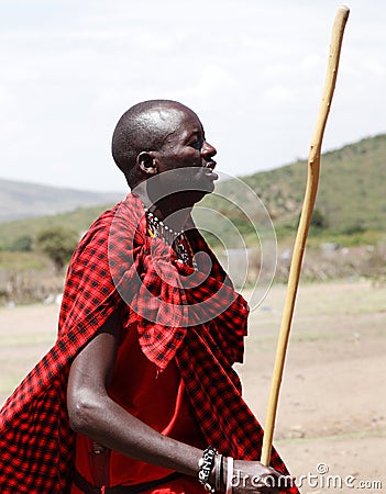 A Masai warrior dancing with a stick