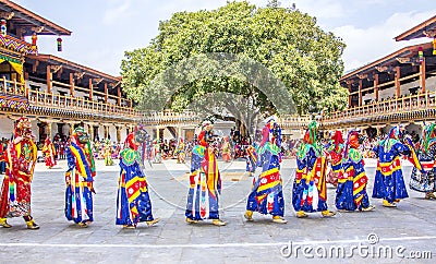 Masked dancers in a row