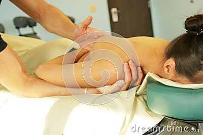 Massage therapy - therapist giving back massage