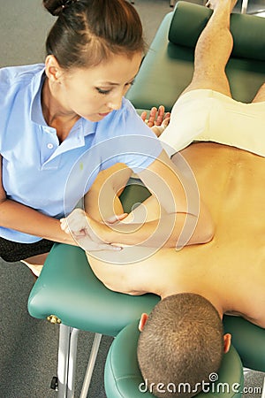 Massage therapy - therapist giving deep tissue massage