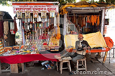 Master of beads works at his stall