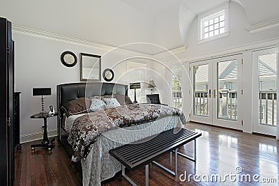 Master bedroom in luxury home with balcony