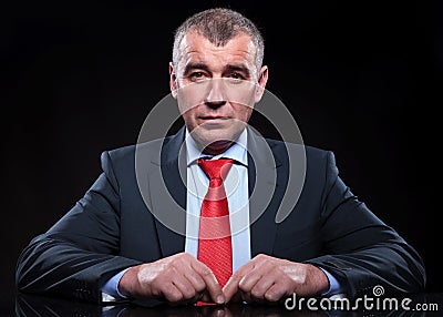 Mature business man sitting at his desk