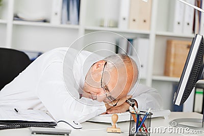 Mature Businessman Sleeping On Desk