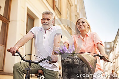 Mature couple on bikes outdoors