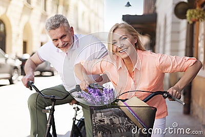 Mature couple on bikes outdoors