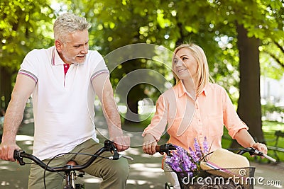 Mature couple on bikes outdoors