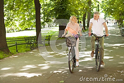 Mature couple on bikes outdoors