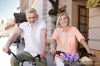 Mature couple on bikes outdoors