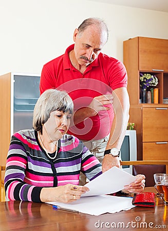 Mature couple calculating family budget