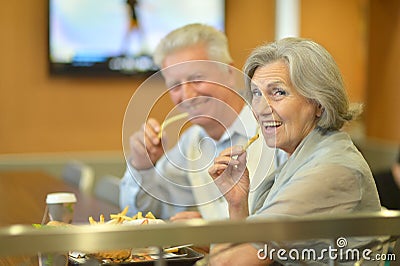 Mature couple eating french fries