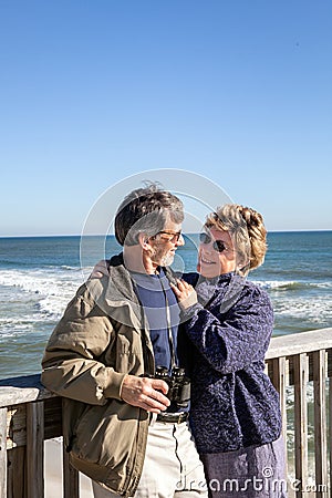 Mature couple enjoy vacation and retirement on Florida fishing pier