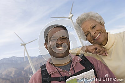 Mature Couple With Map By Wind Farm