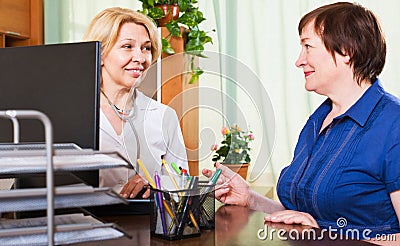 Mature doctor consulting female patient