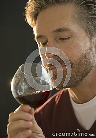 Mature Man Smelling Red Wine