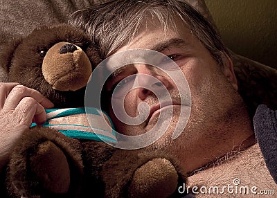 Mature man with teddy bear