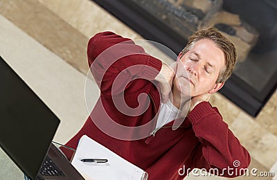 Mature man tired while working at home