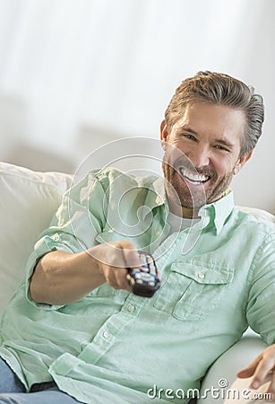 Mature Man Watching TV On Sofa