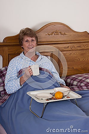 Mature Senior Woman Breakfast in Bed Smiling