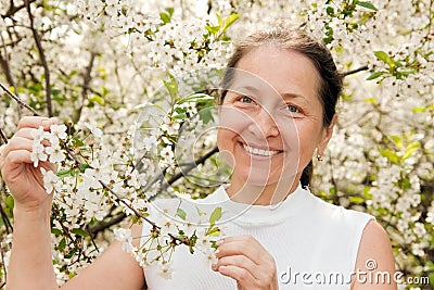 Mature woman with cherry blossoms.