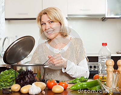 Mature woman cooking soup