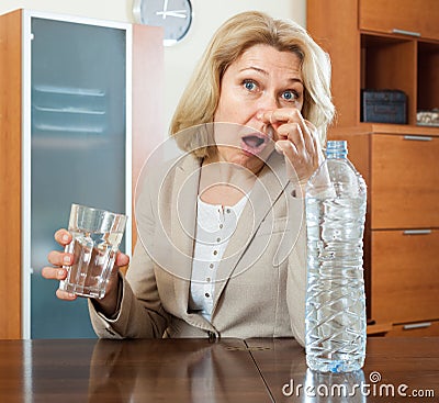 Mature woman with grass of poor quality water