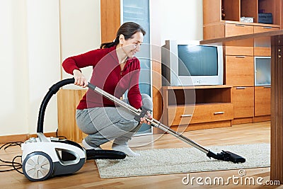 Mature woman with vacuum cleaner