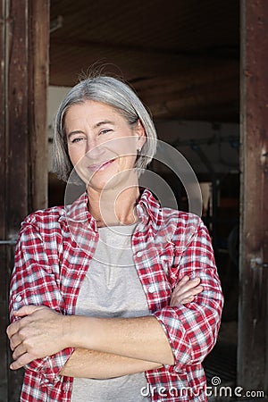 Matured farm woman with crossed arms