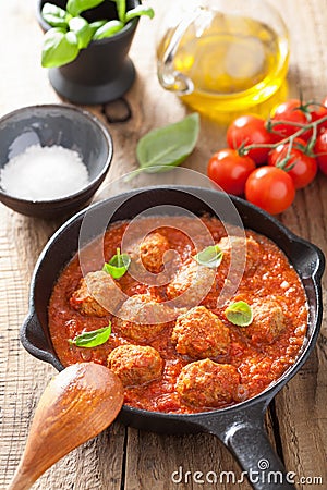 Meatballs with tomato sauce in black pan