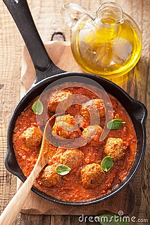 Meatballs with tomato sauce in black pan