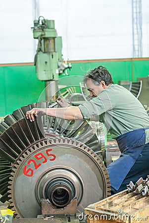Mechanic assembles turbine for aviation engine