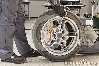 Mechanic changing car tire.