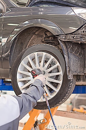 Mechanic changing car wheel.