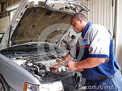 Mechanic Performing a Routine Service Inspection