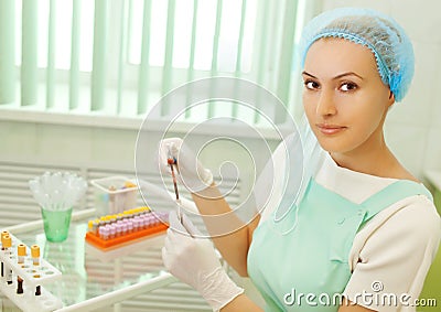 Medical doctor looking on test tube with blood