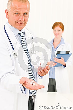 Medical doctor team senior male hold pills
