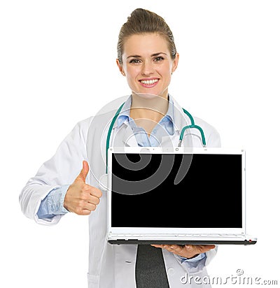 Medical doctor woman showing laptop and thumbs up