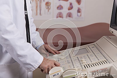 A medical professional uses an ultrasound machine in a doctors o