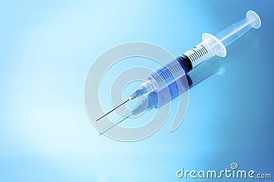 Medical Syringe on glossy background