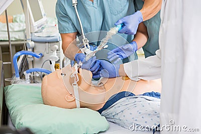 Medical Team Adjusting Endotracheal Tube On Dummy