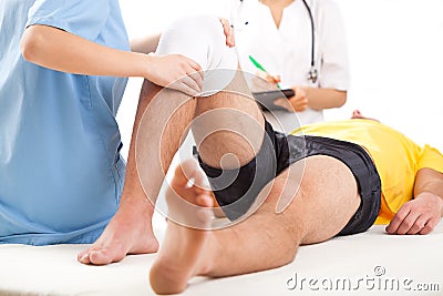 Medical team examining knee condition