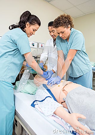 Medical Team Performing CPR On Dummy