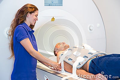Medical technical assistant preparing scan of torso with MRI